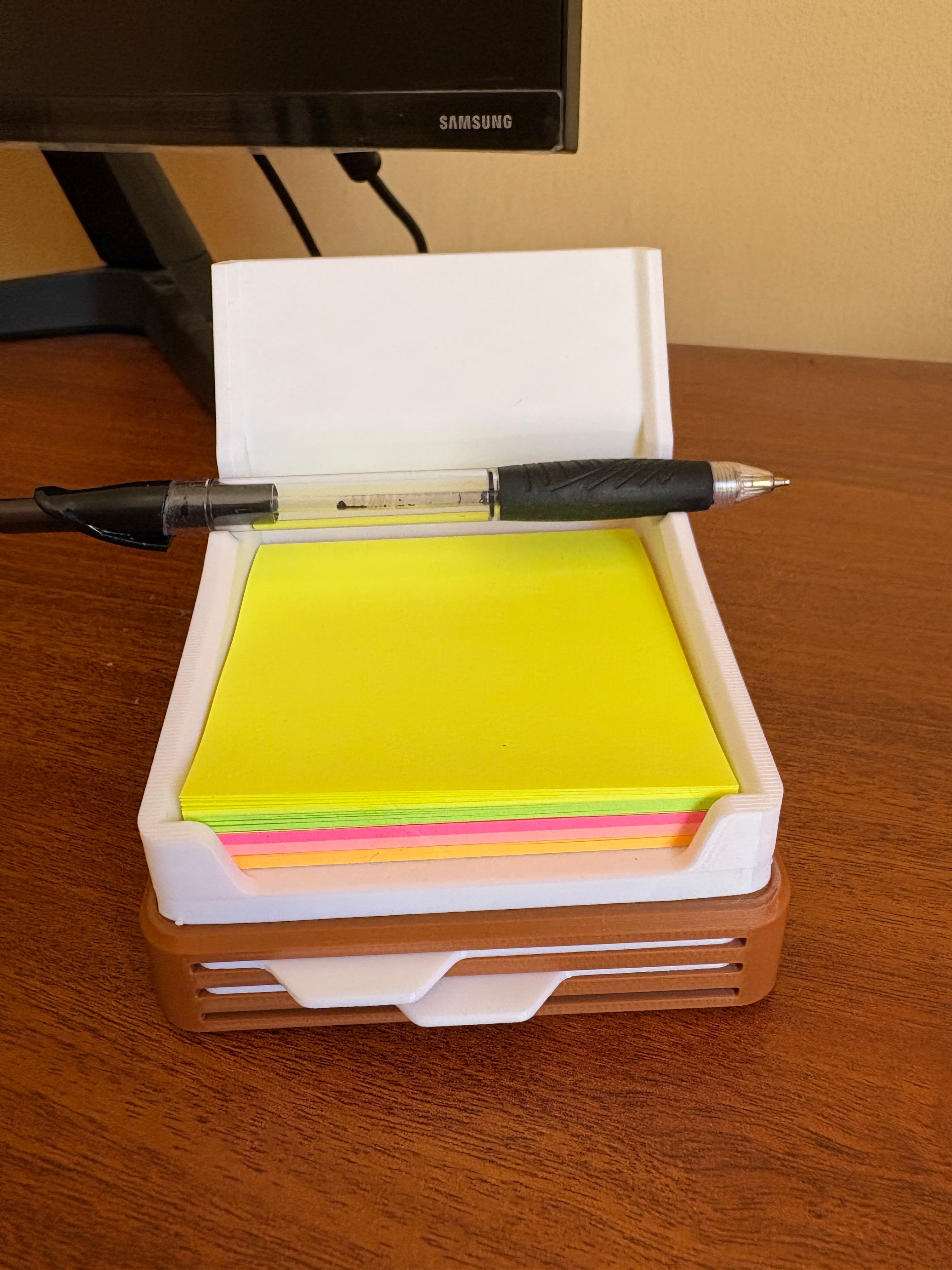 Dispensador de post-its visto de costado con lapicera
